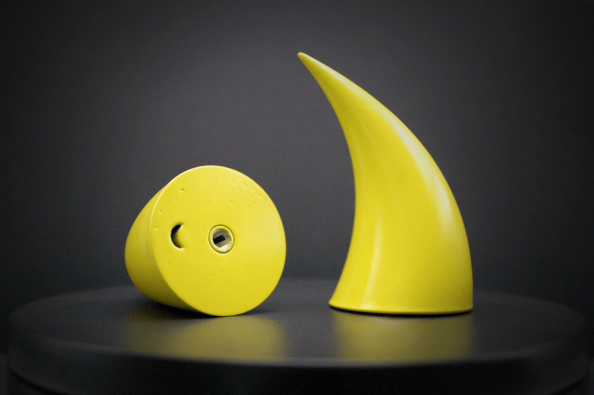 Bottom view of imp devil horns in sulfur yellow with a glossy finish, showing a threaded insert on the base.