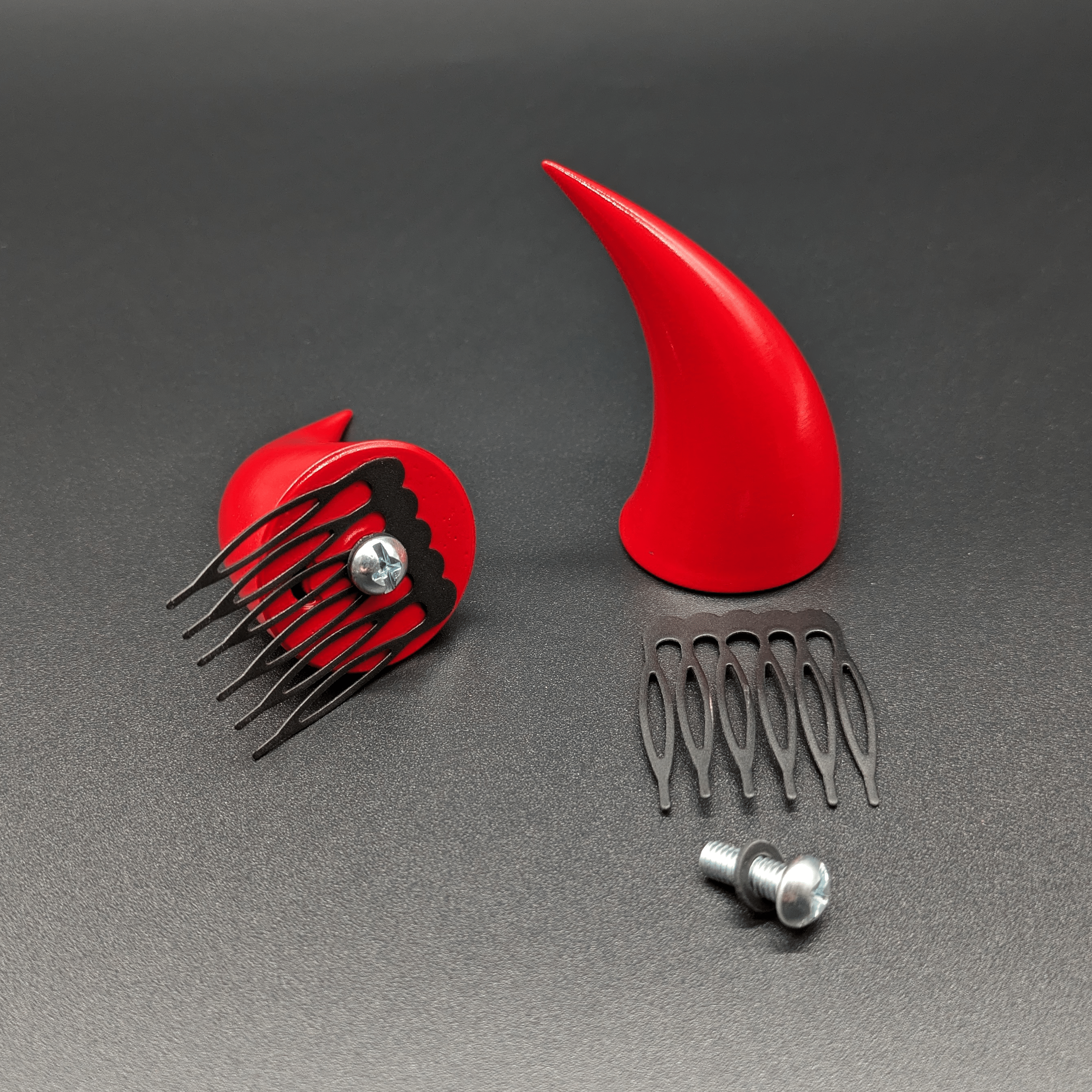 Catacomb hair comb attachments demonstrated on two scarlet red incubus horns. The catacomb attaches to the horn with a screw and a silicone washer.