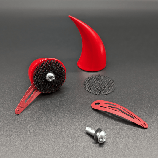 Two scarlet red incubus horns and two hellcrow discs, with one horn detached showing the hellcrow disc, barrette clip, washer, and screw.