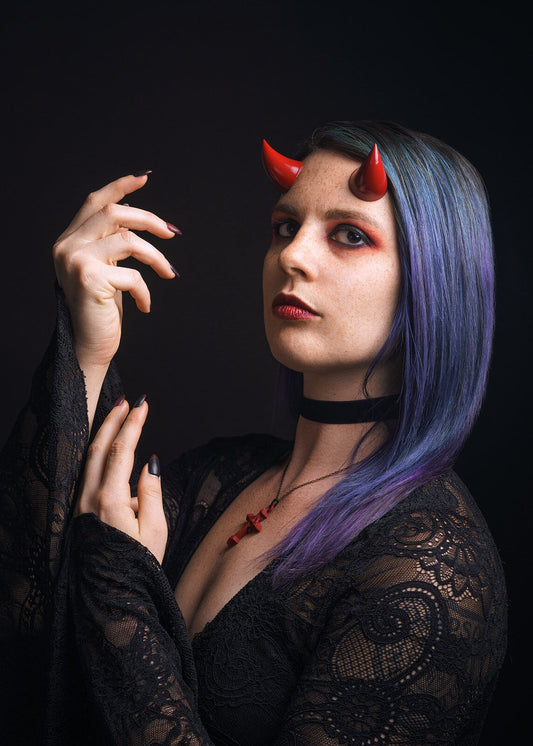 Model Splitty Kitty poses in gothic attire wearing red imp horns on her forehead. Photo by Brian Keyes.