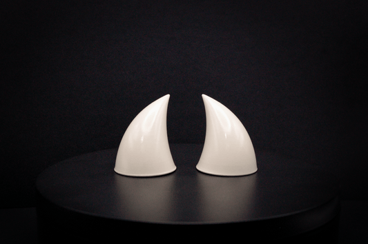 Front view of imp devil horns in bone white with a glossy finish.