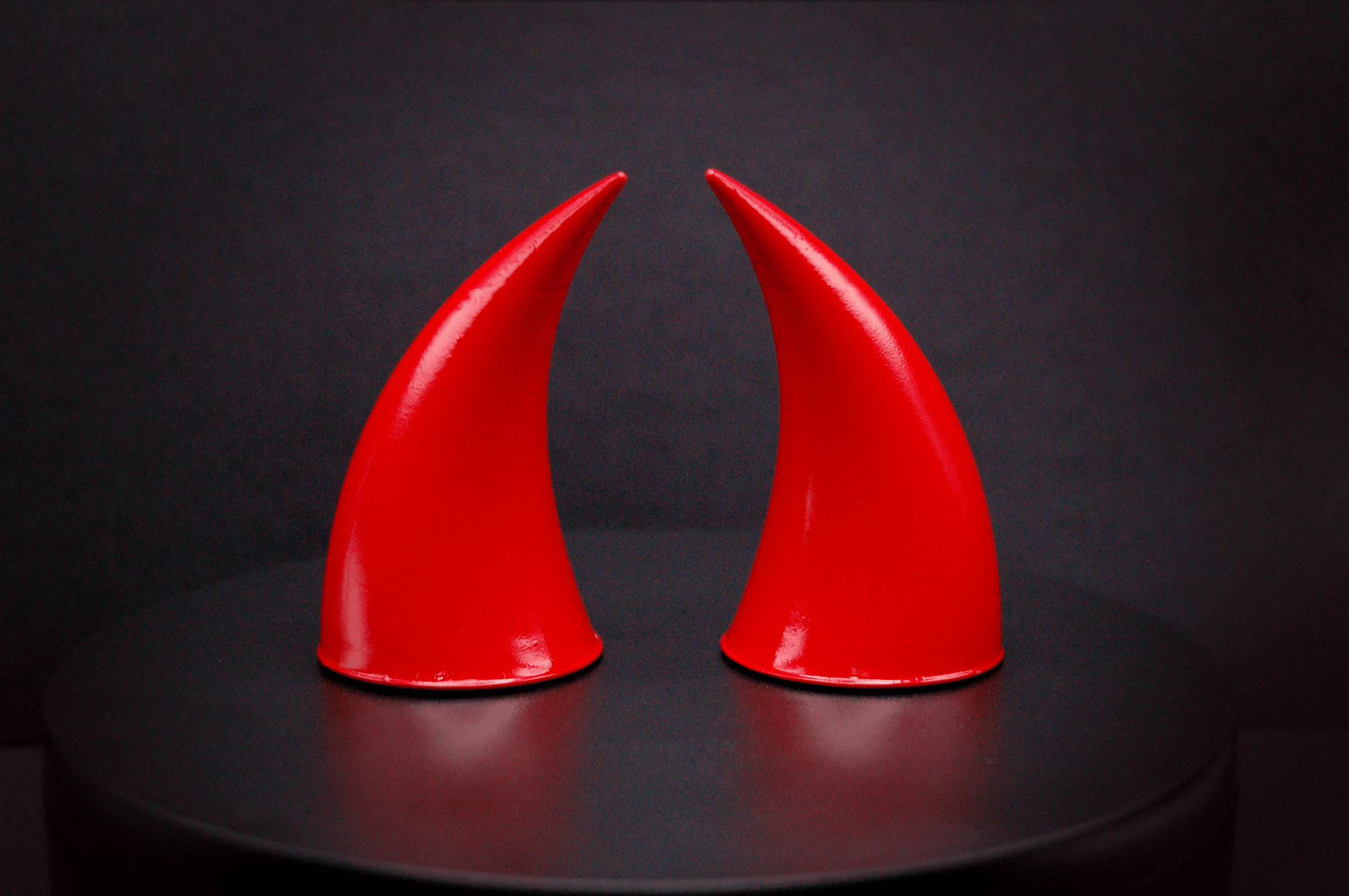 Back view of incubus devil horns in scarlet red with a glossy finish.