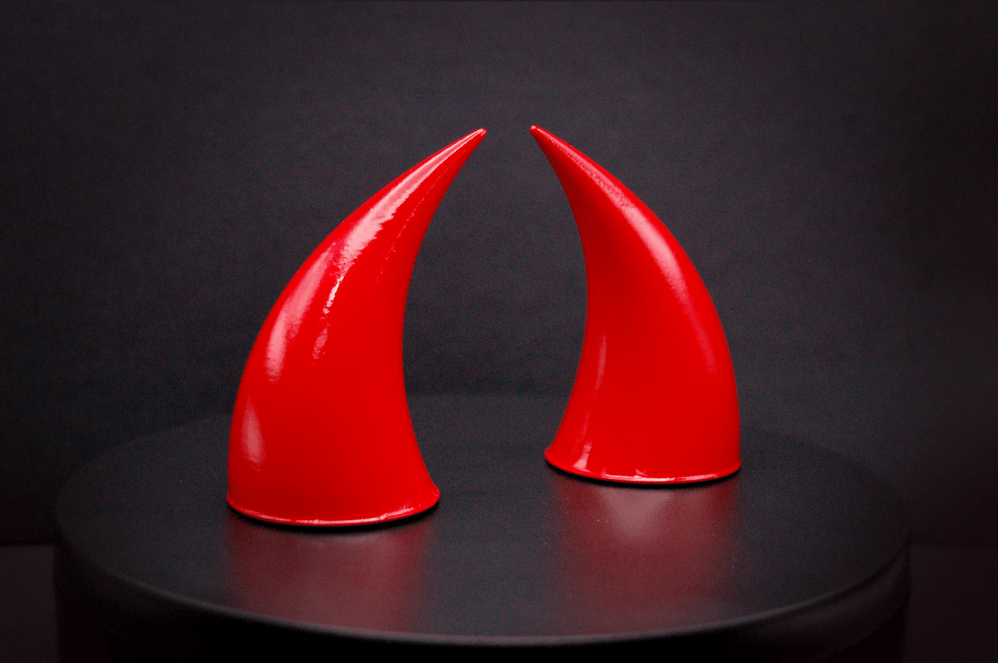 Side view of incubus devil horns in scarlet red with a glossy finish.