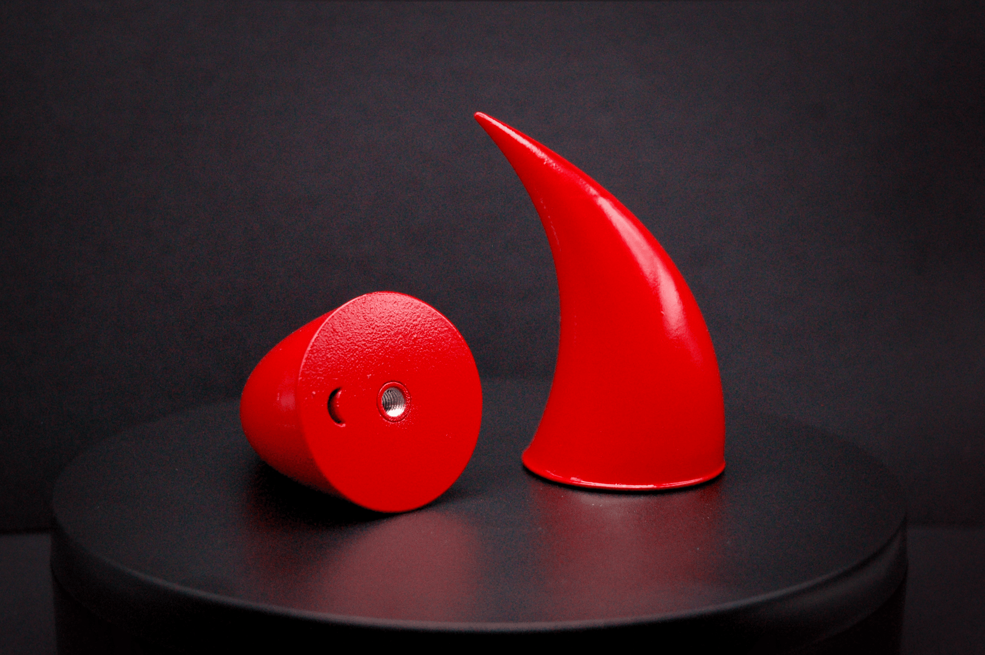 Bottom view of incubus devil horns in scarlet red with a glossy finish, showing a threaded insert on the base.