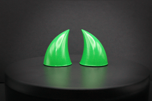 Front view of imp devil horns in goblin green, a bright green with a glossy finish.