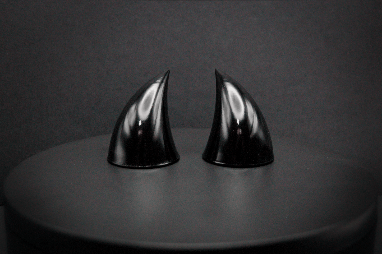 Front view of imp devil horns in black with a glossy finish.