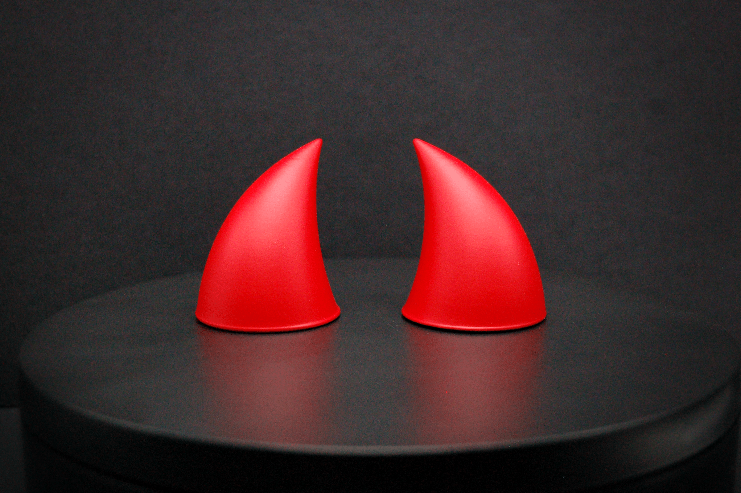 Front view of imp devil horns in scarlet red with a matte finish.