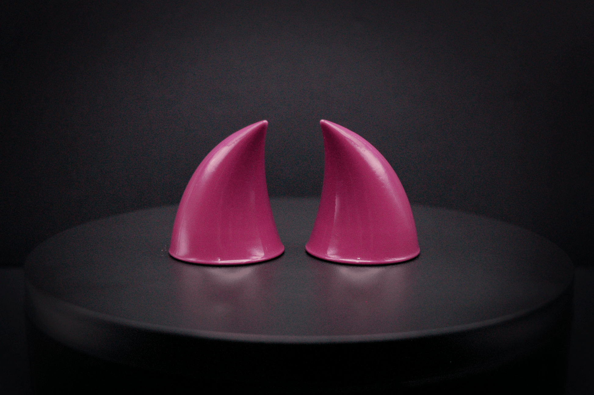 Back view of imp devil horns in deep rose with a glossy finish.