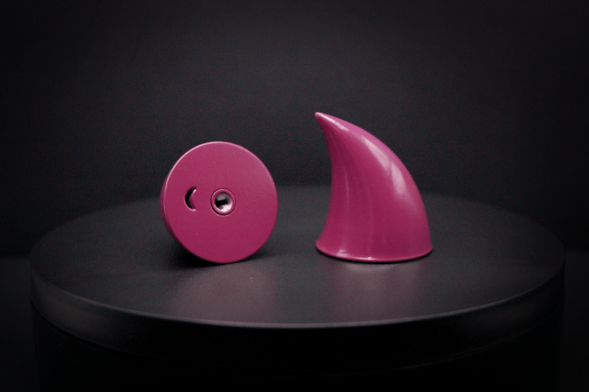 Bottom view of imp devil horns in deep rose with a glossy finish, showing a threaded insert on the base.