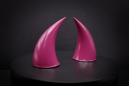 Side view of incubus devil horns in deep rose with a glossy finish.