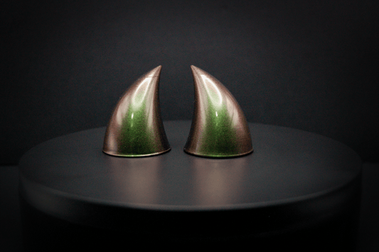 Front view of imp devil horns in metallic coppery green.