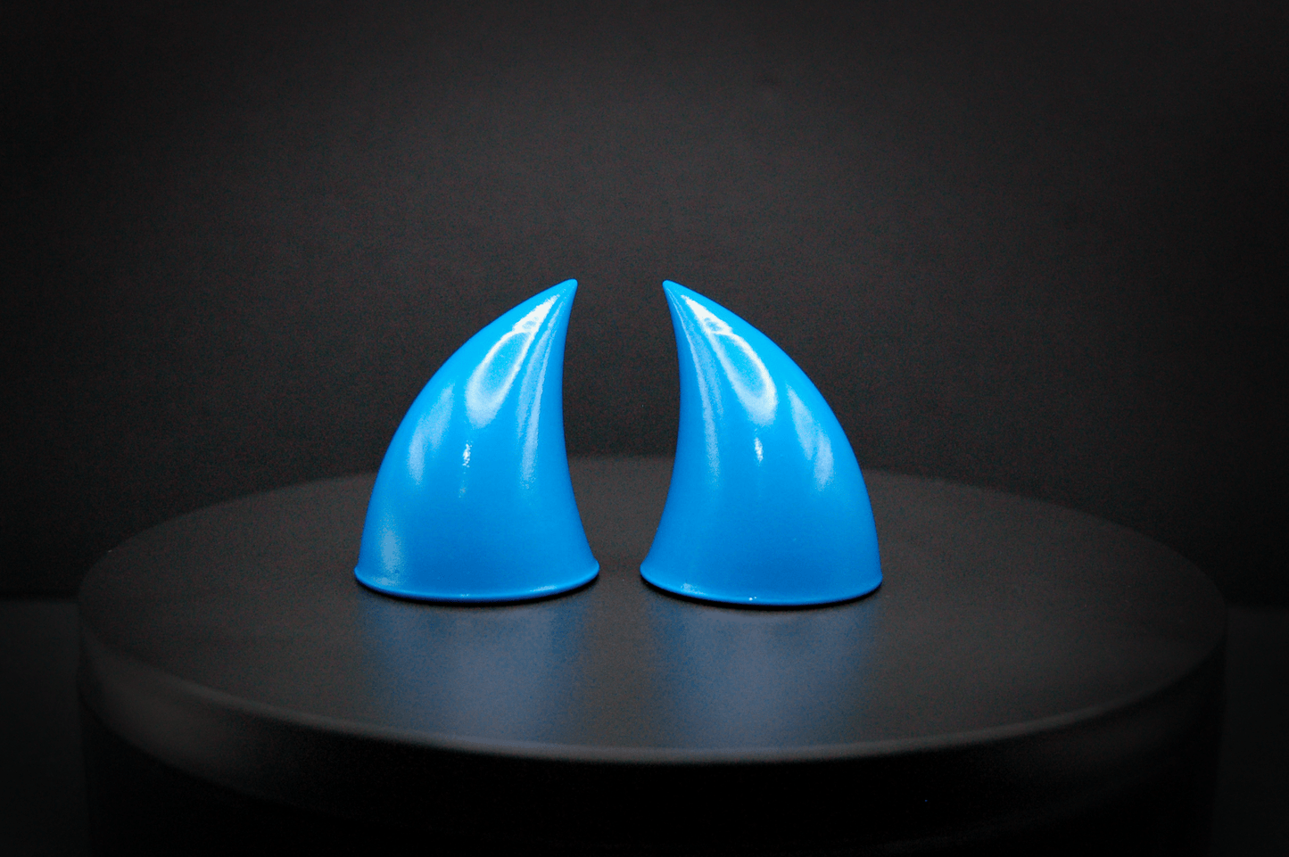 Front view of imp devil horns in nixie blue, a turquoise color with a glossy finish.