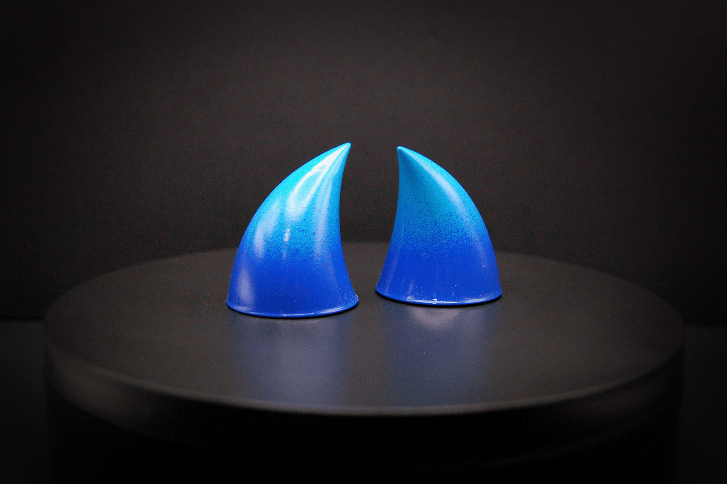 Side view of imp devil horns in a royal blue to sky blue ombré with a glossy finish.