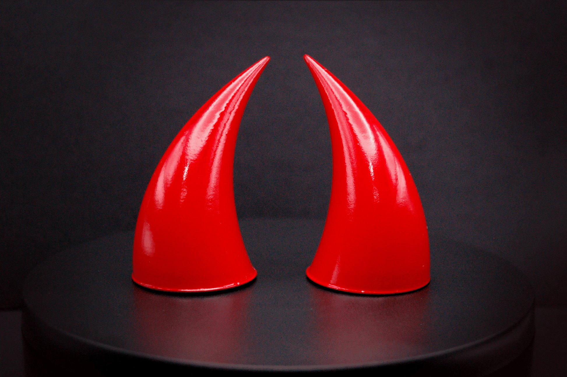 Front view of incubus devil horns in scarlet red with a glossy finish.